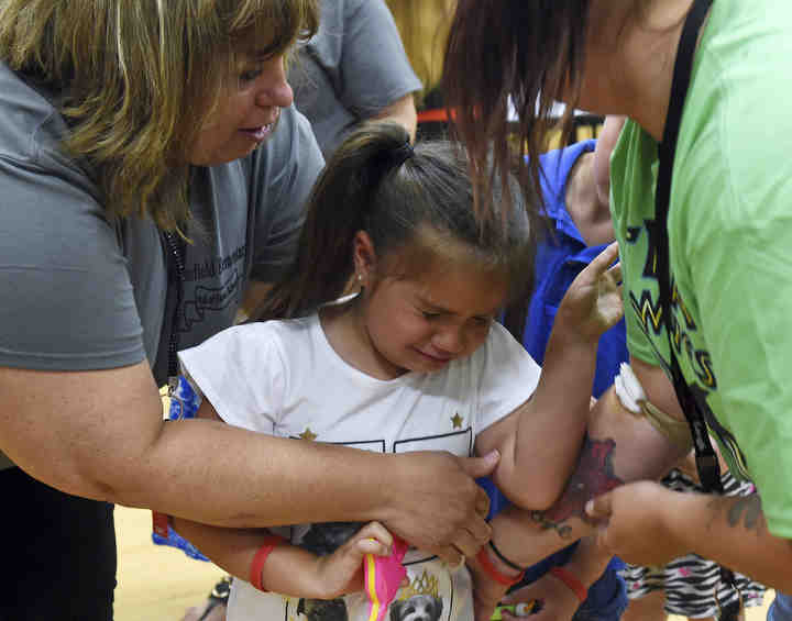 Brimfield Elementary throws a celebration for being a 2018 Hall of Fame School. Elizabeth Sevier turns to her mother Brittney Rutherford in tears after saying goodbye for the summer to her kindergarten teacher Terri Gempel.   (Lisa Scalfaro / Record-Courier)